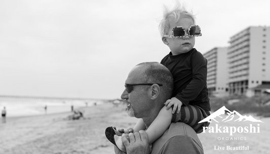 Grandparent carrying grandchild on shoulders demonstrating strength, mobility, and vitality across generations