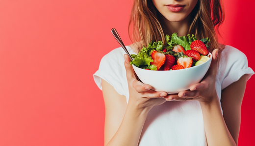 Woman holding fresh colorful salad bowl representing healthy eating, balanced nutrition, and whole food choices for wellness