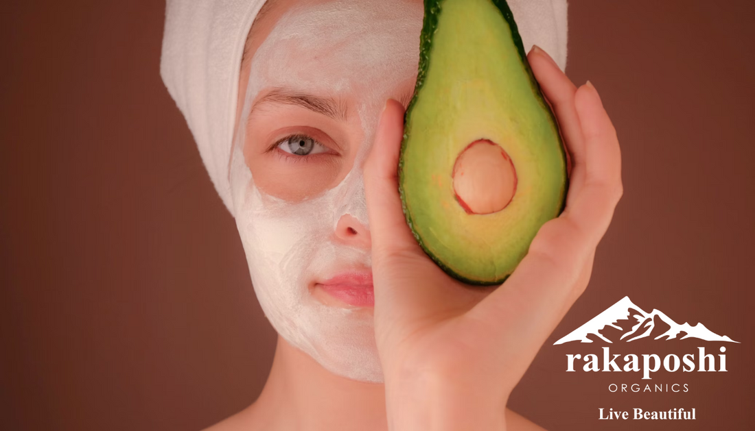 Woman with natural face mask holding avocado representing nutrient-rich foods and holistic approach to skin and beauty wellness