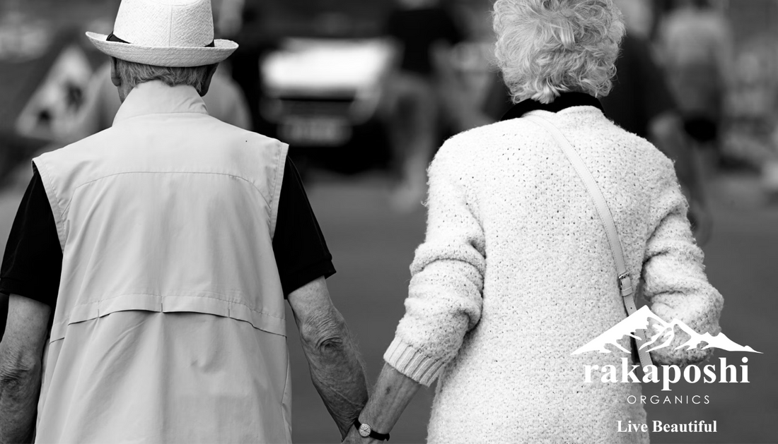 Active elderly couple walking together outdoors demonstrating healthy aging and physical vitality